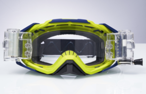  A pair of bright lime green and navy blue motocross goggles with attached clear camera mounts are displayed on a white surface against a light gray background.