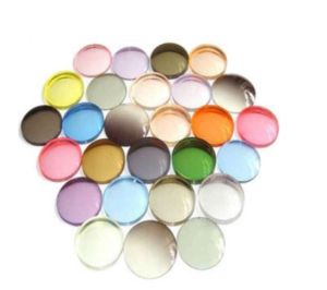 The image shows a collection of round, colored lenses or discs arranged in a loose pile.  The colors are diverse and range from pastels to more vibrant hues.  They appear to be translucent or semi-transparent.
